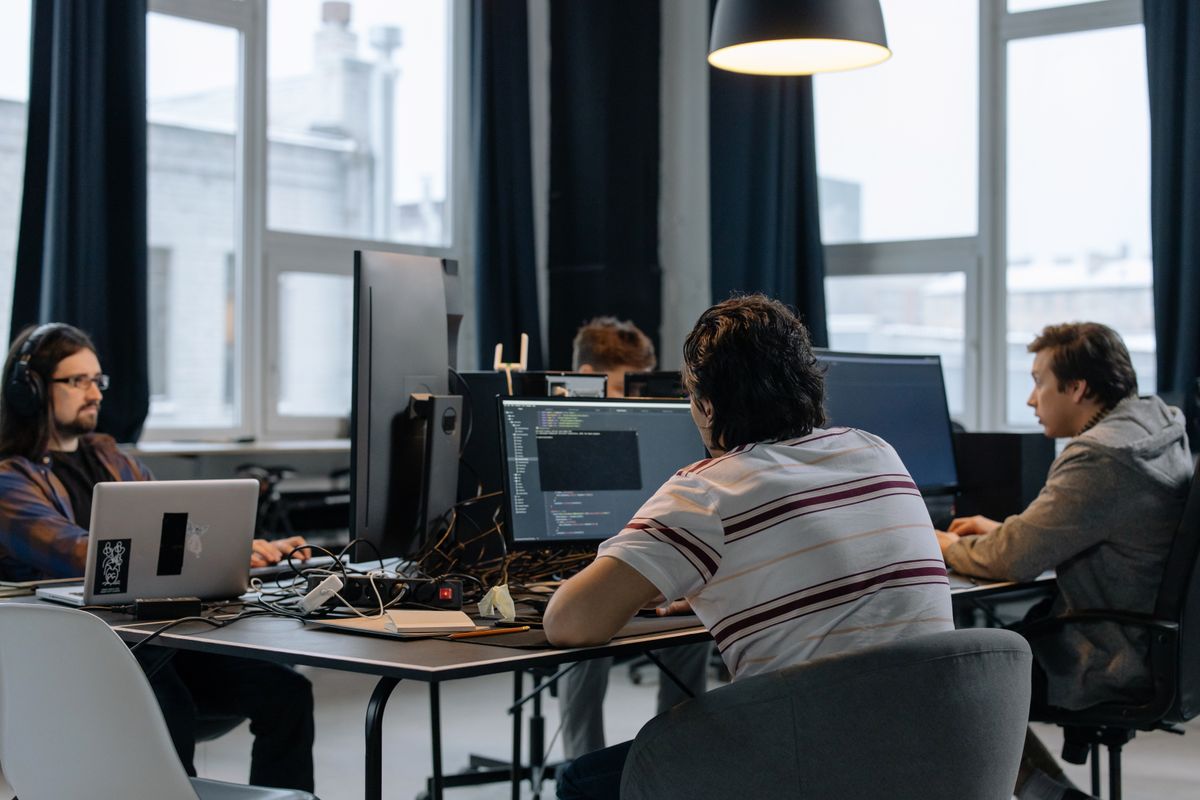 Source photo of developers collaborating in a technology workspace