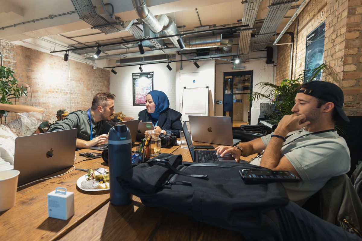 Source photo of a team working with technology in a modern office